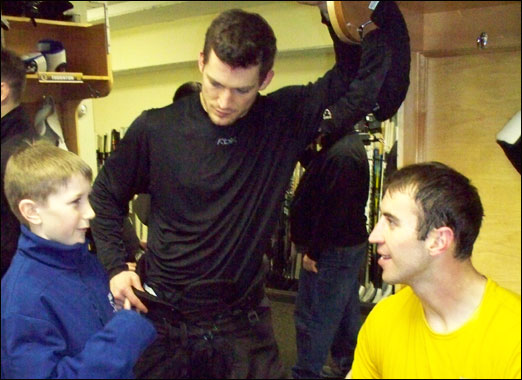 Logan in the Boston Bruins dressing room in March. Zheno Chara (right) climbed Mount Kilimanjaro to raise funds for improving lives in Africa and Andrew Ference (left) is active in supporting African communities.