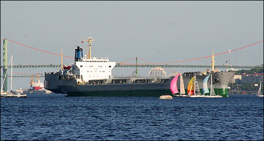 Sailboats race around an anchored ship in the Bedford Basin on a warm and sunny Wednesday evening. Photo: Reed Holmes