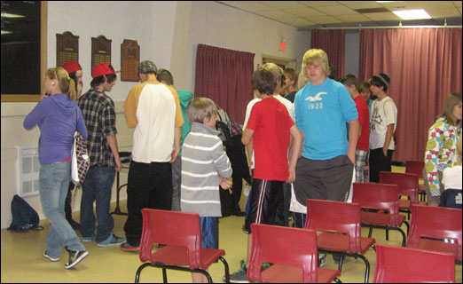 A group of youths eagerly lines up to sign their names on a sheet at the preliminary meeting to determine whether Bedford youths want a bike/skate park in town.