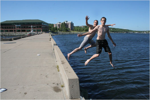 A couple of crazy Bedfordites jump off the jetty at the Bedford Waterfront on a hot and humid Friday afternoon. Photo by Ken Currie
