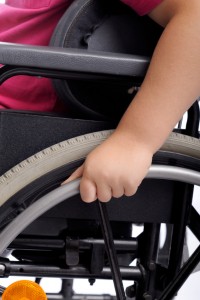 close-up on hand of handicapped child in wheelchair