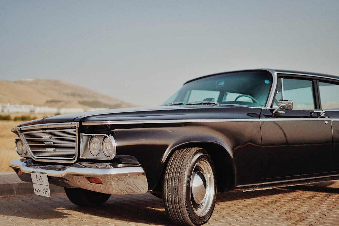 Free A classic Chrysler Newport car captured in a sunny outdoor setting, showcasing its vintage charm. Stock Photo