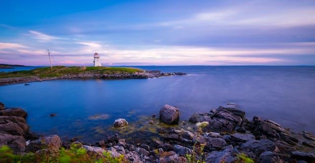 A picturesque view of the sea and a lighthouse in the distance. 