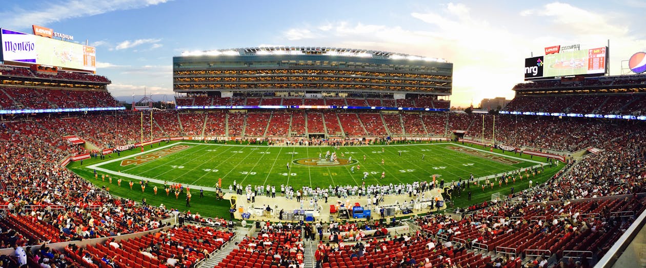 Free A stunning panoramic shot of Levi's Stadium in Santa Clara during a packed football game at sunset. Stock Photo